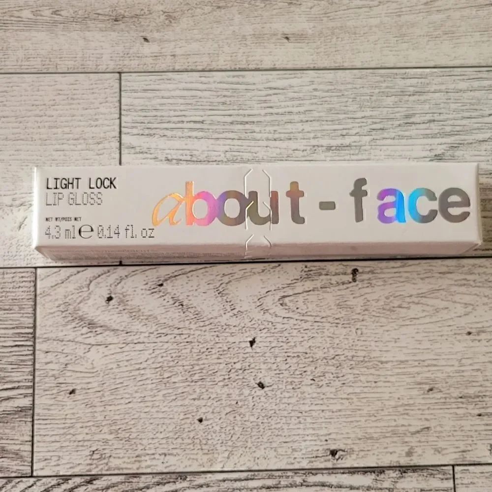 About Face Light Lock Lip Gloss in Angel on Fire